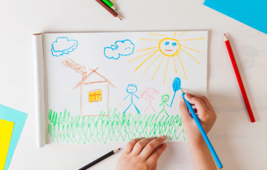 Child draws a pencil drawing of the house and his family. Child draws a pencil drawing of the house and his family. New home. Top view.